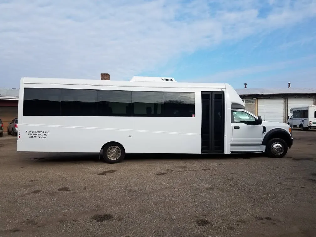 White B & W Charters mini coach parked at the Kalamazoo lot